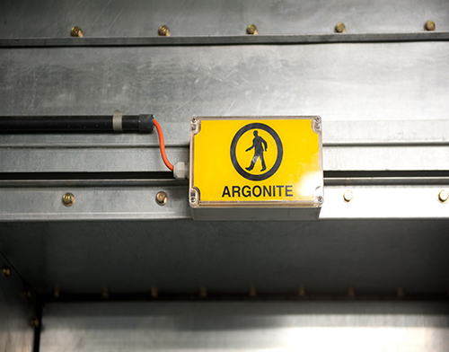 Een geel bordje van argonite hangt boven de deur in de e-bunker