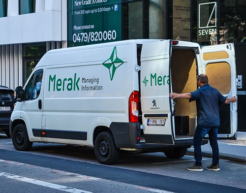 Un coursier de Merak ferme les portes de sa camionette