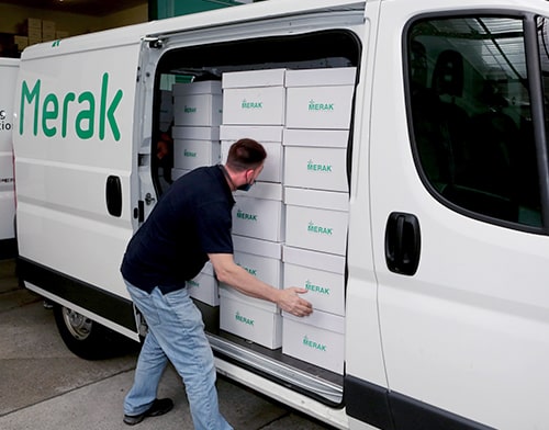 Un coursier de Merak charge une camionnette avec des boîtes d'archives
